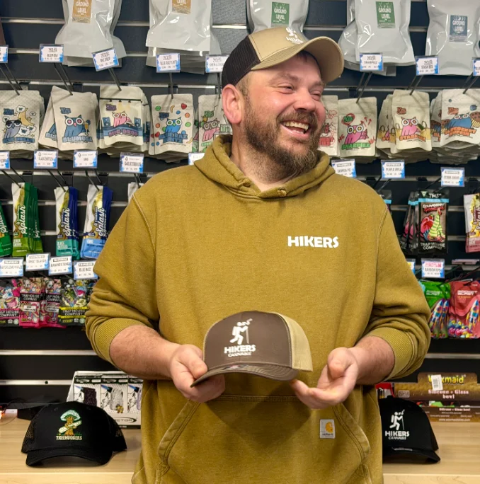 A budtender at the counter in natural light
